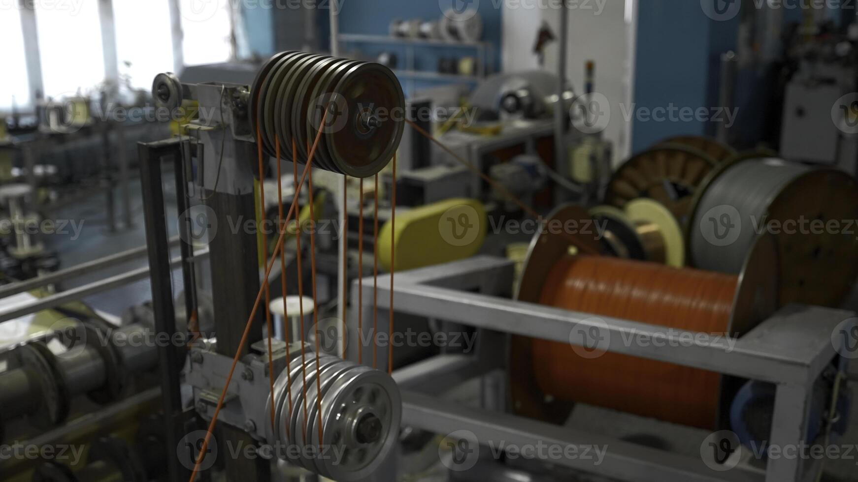 Steel wire coils at a tire factory. Creative. Rotating and reeling metal threads bobbins at modern tire production plant. photo