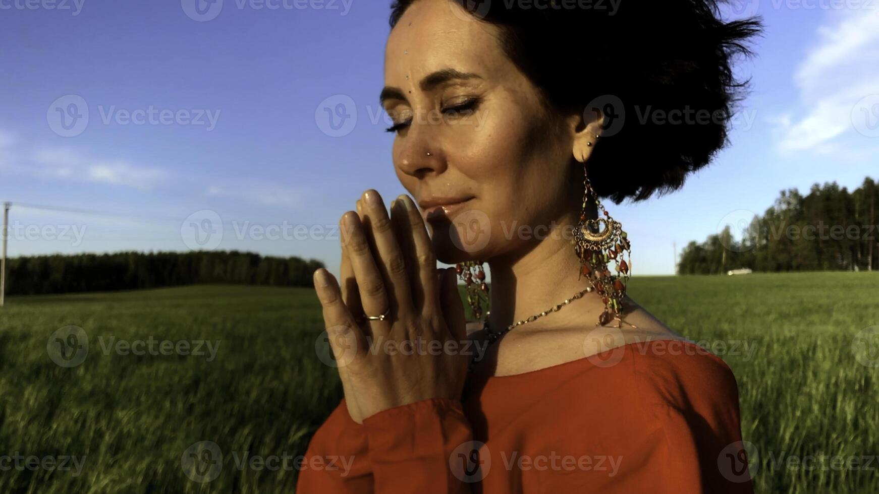 Believing woman with her eyes closed asking for forgiveness and peace. Stock clip. Feeling unity with nature. photo