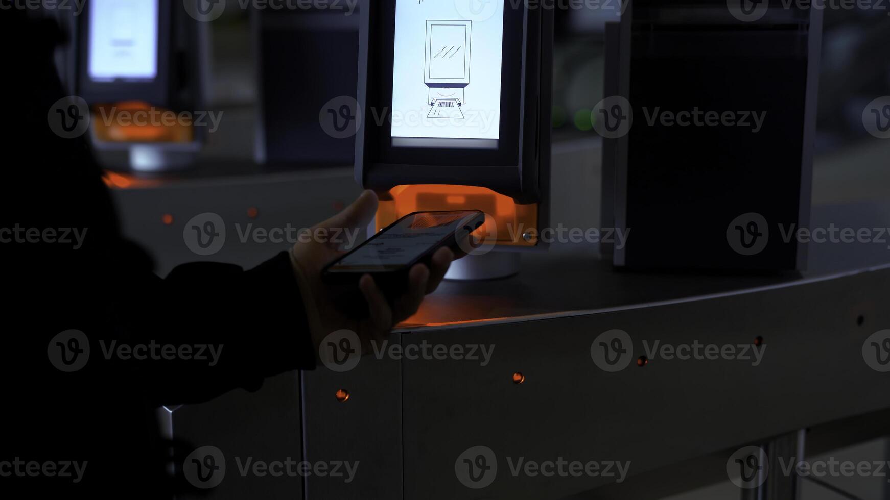 Close-up of passing through electronic turnstile with barcode scanner. Media. Using smartphone to get access inside the building. photo