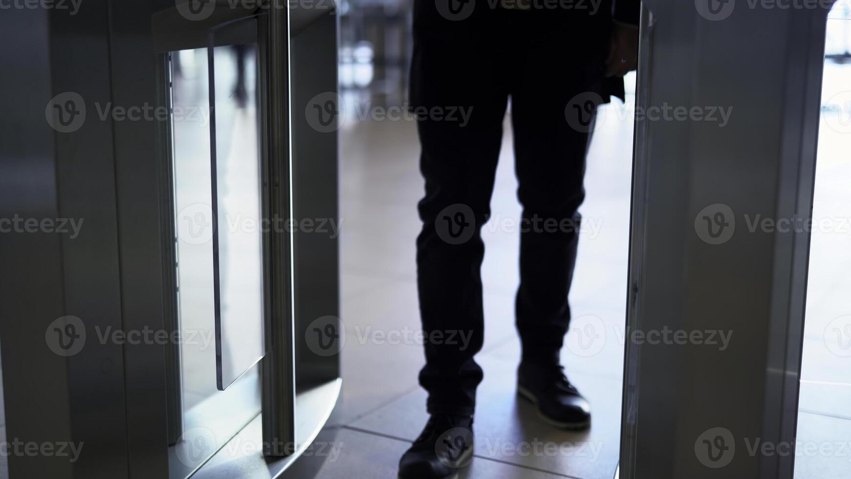 Man passing through the security gates. Media. Man using turnstile to enter the shopping center or subway. photo