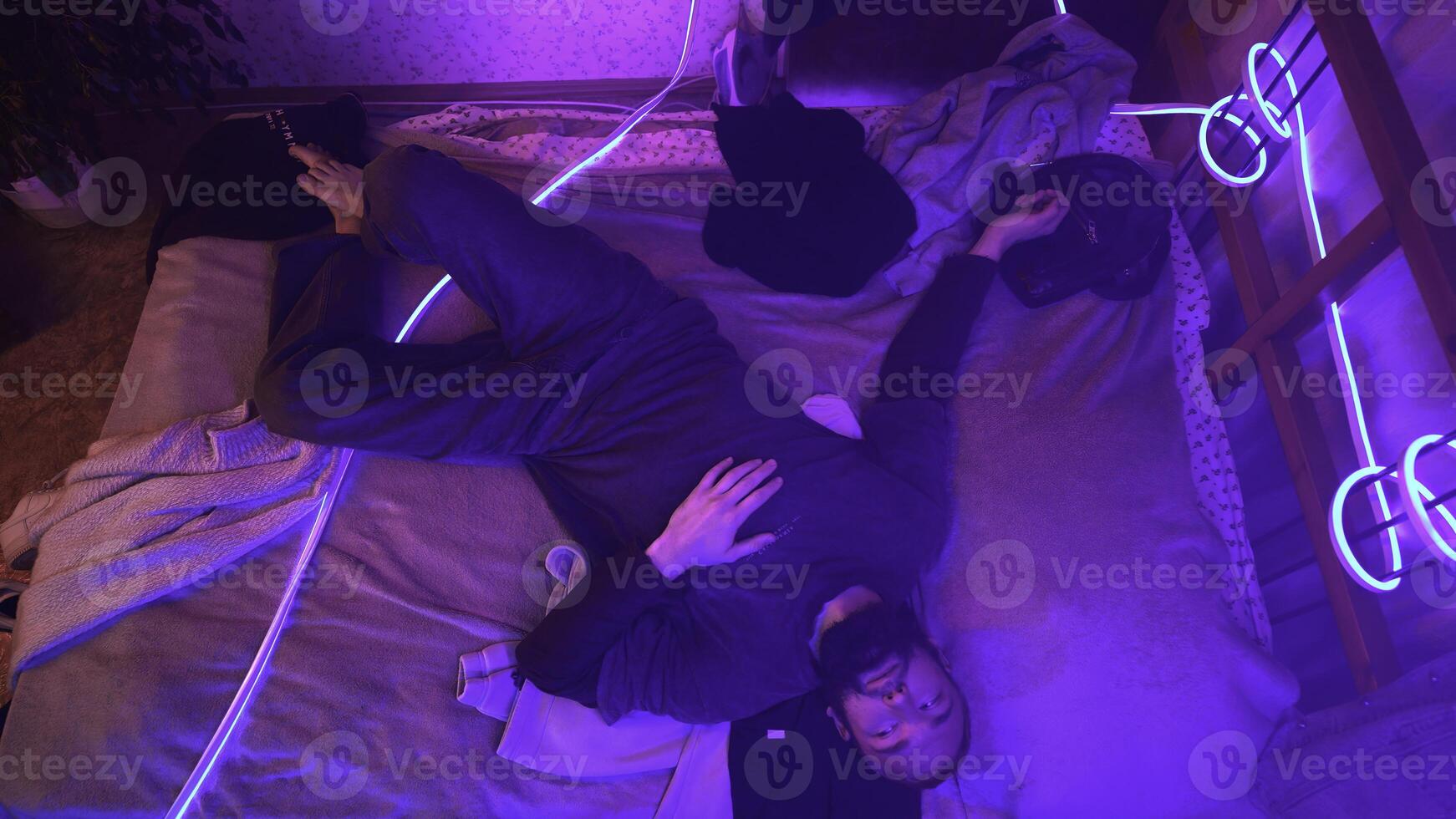 Stressed man on bed late at night suffering from insomnia. Media. Awake in the middle of the night, top view. photo