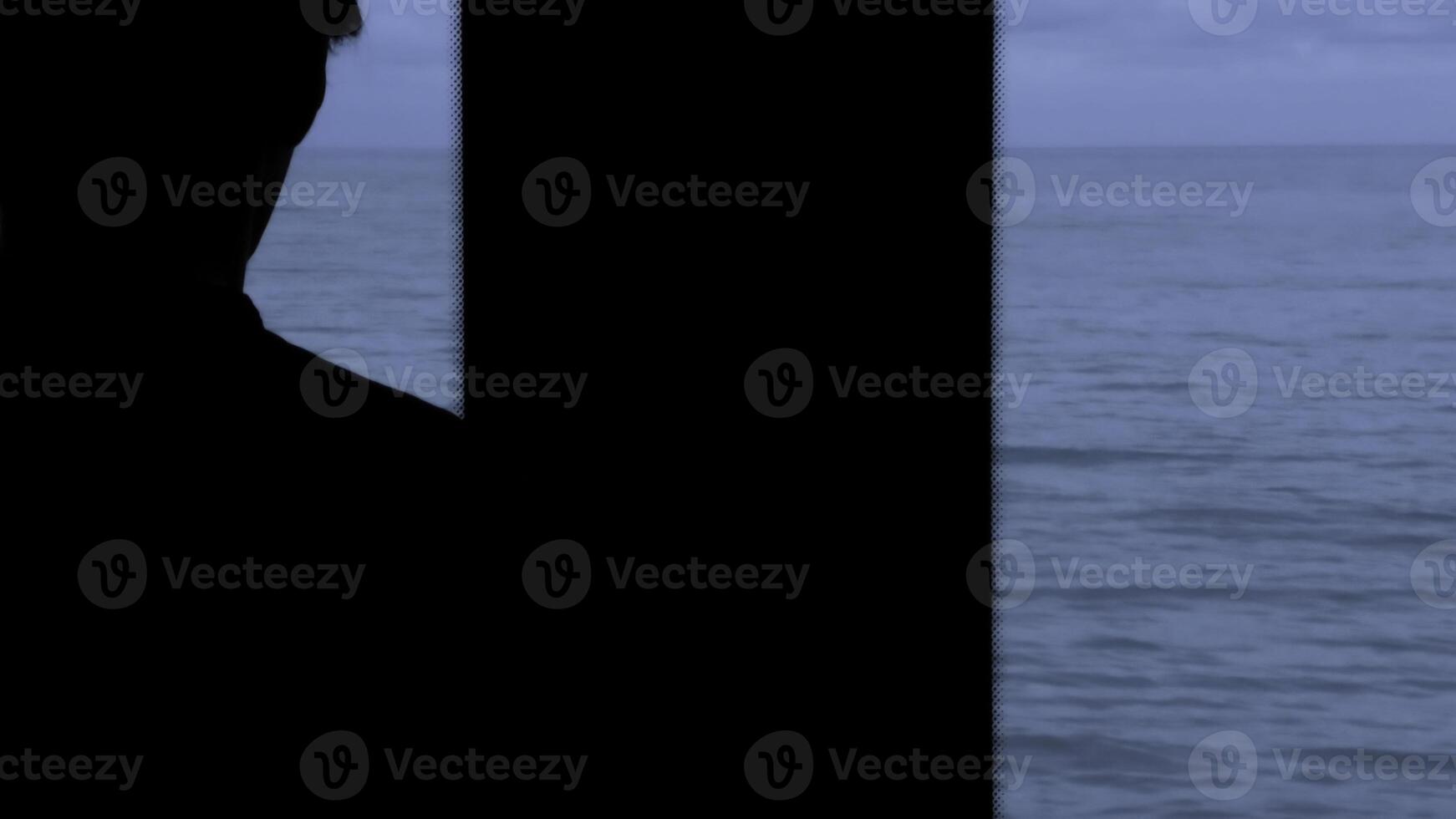 Man traveling by train and looking through the window at the sea. Stock clip. Beautiful late evening seascape from the moving train. photo