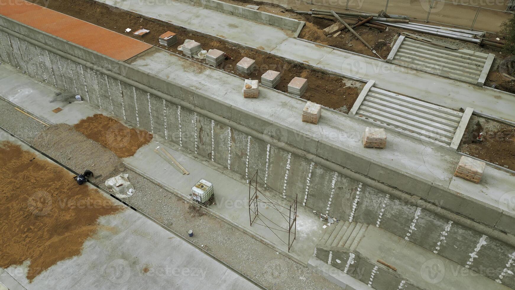 Aerial view of construction site on city embankment. Clip. Process of improving pedestrian road. photo