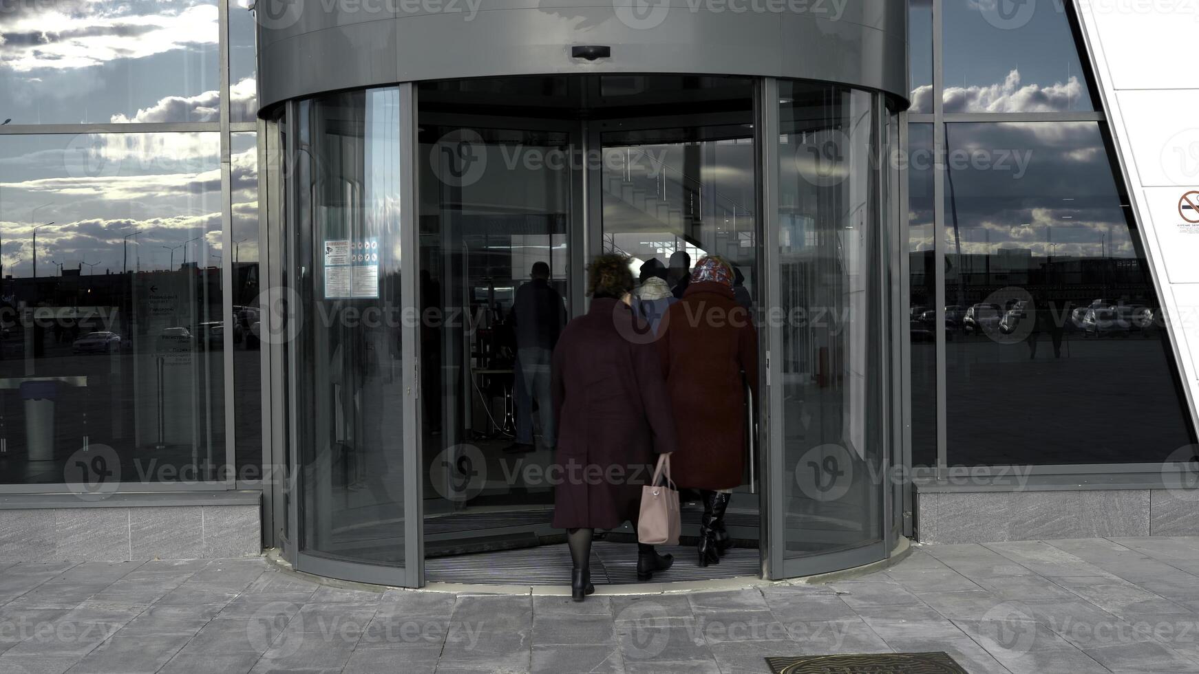 un giratorio puerta en moderno edificio, compras centro. medios de comunicación. vaso giratorio puerta, placa giratoria Entrada a el negocio centro, hora lapso. foto