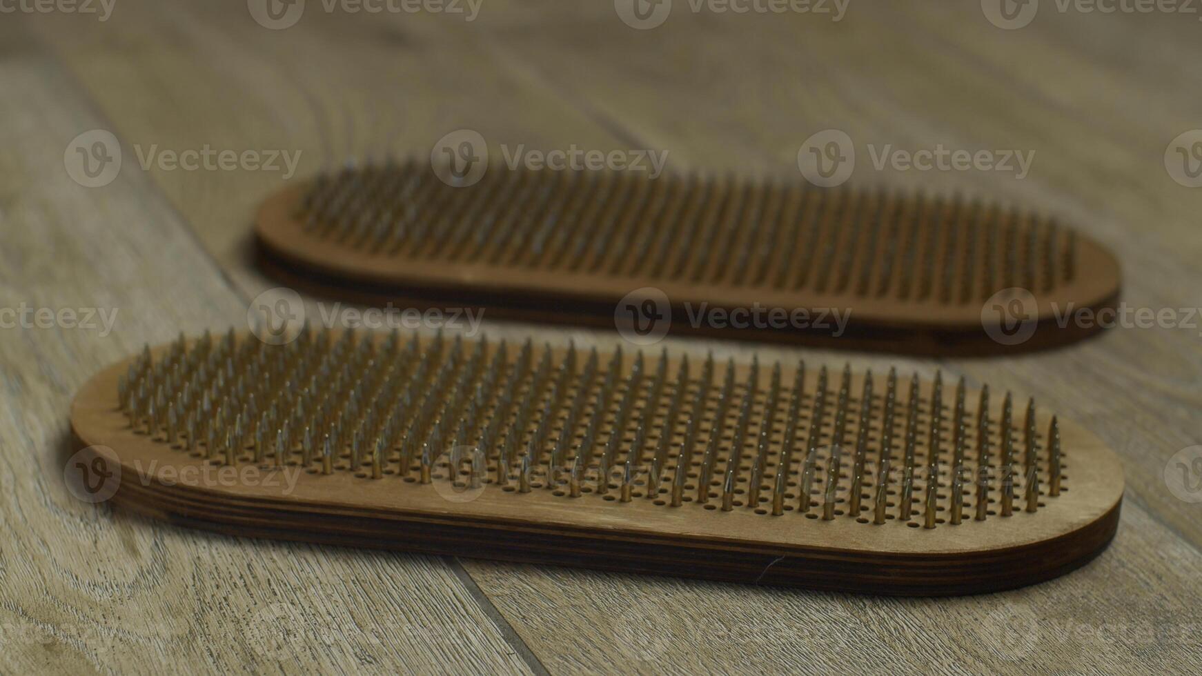 Wooden sadhu board for standing on nails, indoors yoga practice. Media. Woman feet trying to stand on nails. photo