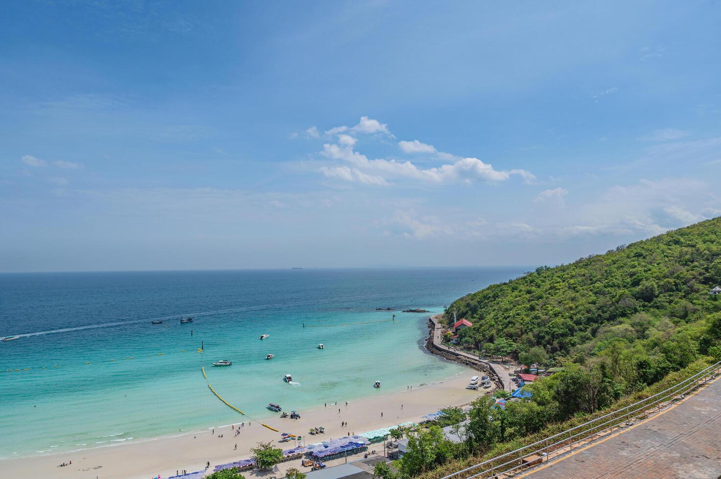 Landscape view of tawean beach with crowded of tourist on the beach in cloudy day.Tawaen Beach is the main Beach on the popular Koh Larn Island. photo