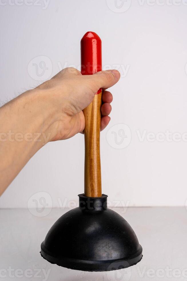 Man using plunger to clear sink blockage on white background with copy space photo
