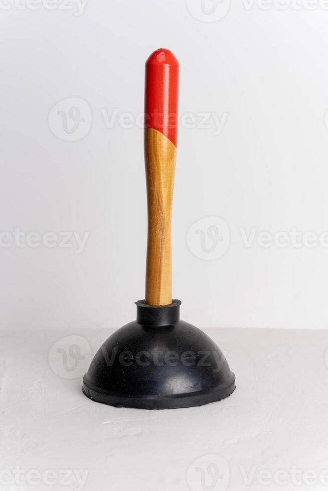 Plunger for cleaning sink blockages on white background with copy space photo