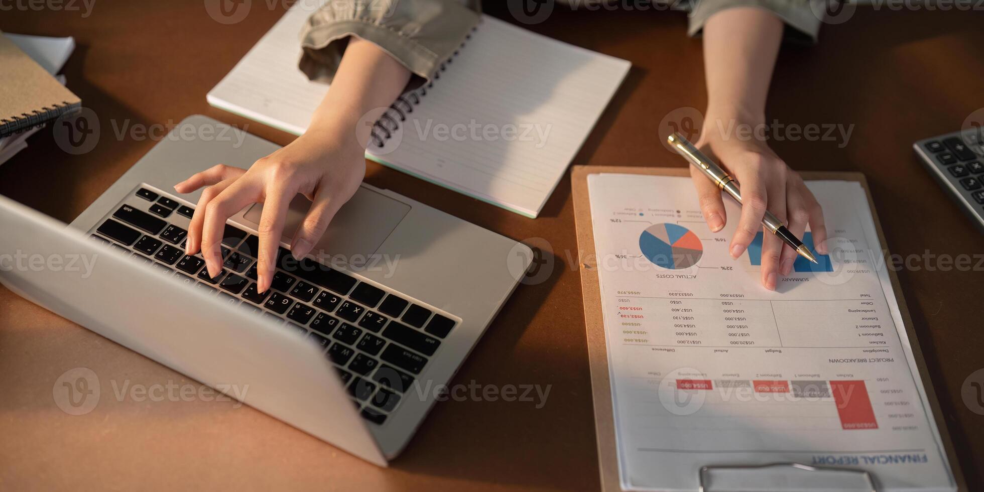 Businesswoman using laptop computer and working at office with calculator document on desk, doing planning analyzing the financial report, business plan investment, finance analysis concept photo