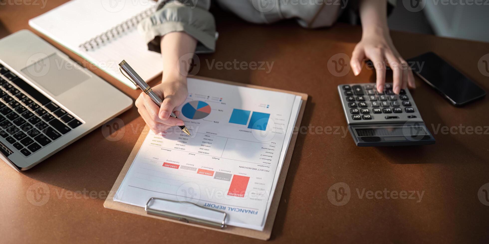 Businesswoman using laptop computer and working at home with calculator document on desk, doing planning analyzing the financial report, business plan investment, finance analysis concept photo