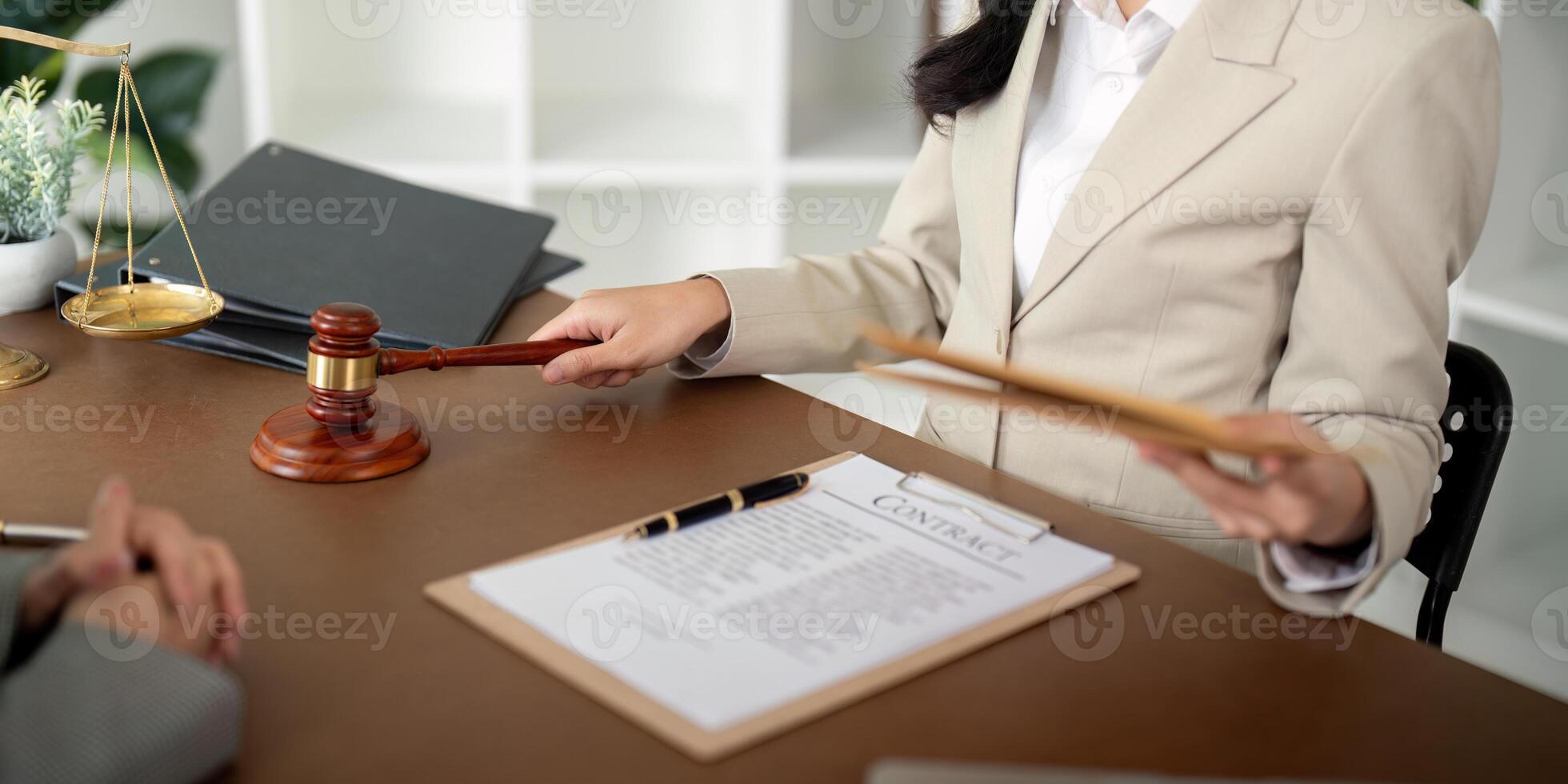 Business people and lawyer discussing contract papers sitting at the table. Concept of law, advice, legal services photo