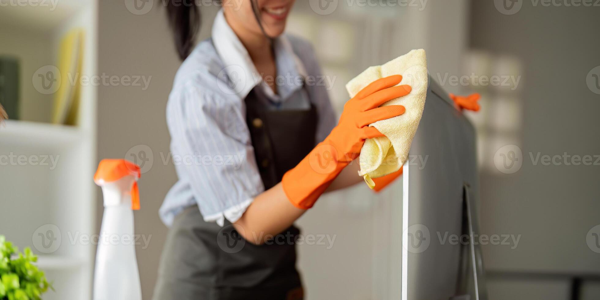 Woman clean in office room at office. Housekeeper or maid cleaner feel happy wipe mop and clean the work desk. the office office cleaning staff photo