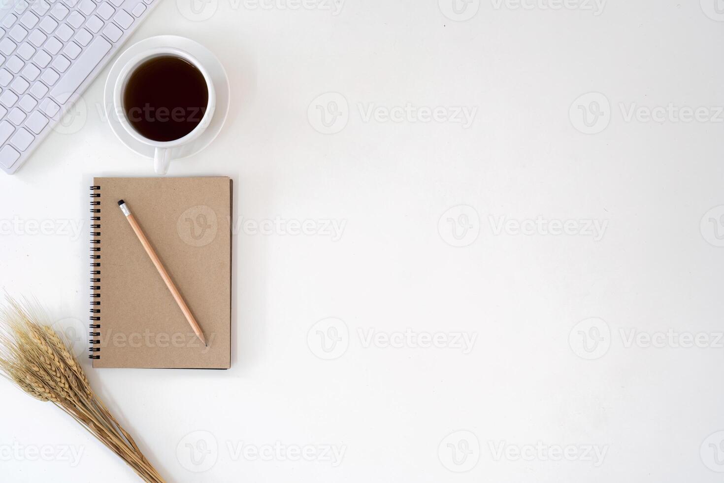 Top view with copy space for your text. keyboard, cup of coffee and notebook on white background photo
