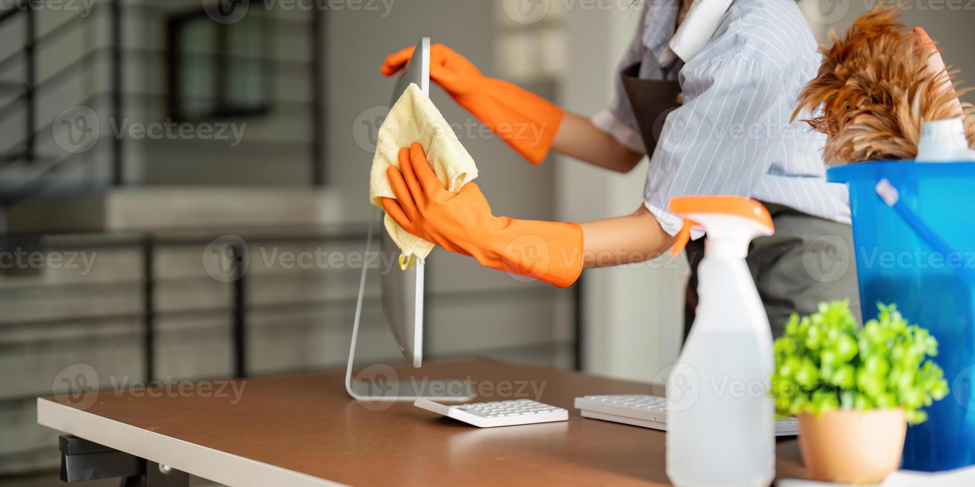 Woman clean in office room at office. Housekeeper or maid cleaner feel happy wipe mop and clean the work desk. the office office cleaning staff photo