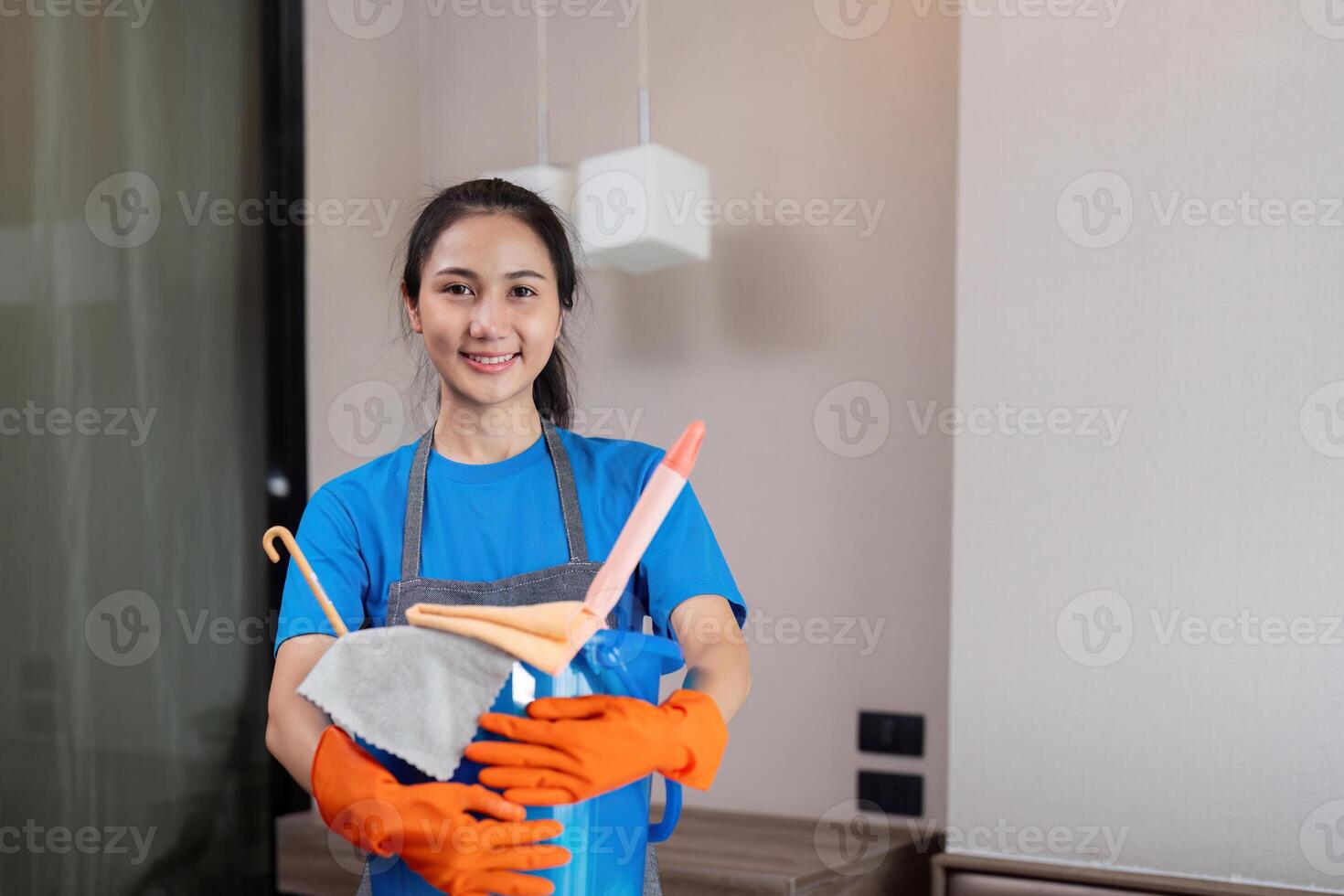 Cleaning product, and basket with woman asian staff cleaning service in bedroom to clean bacteria at apartment. cleaner or maid with container to work in room photo