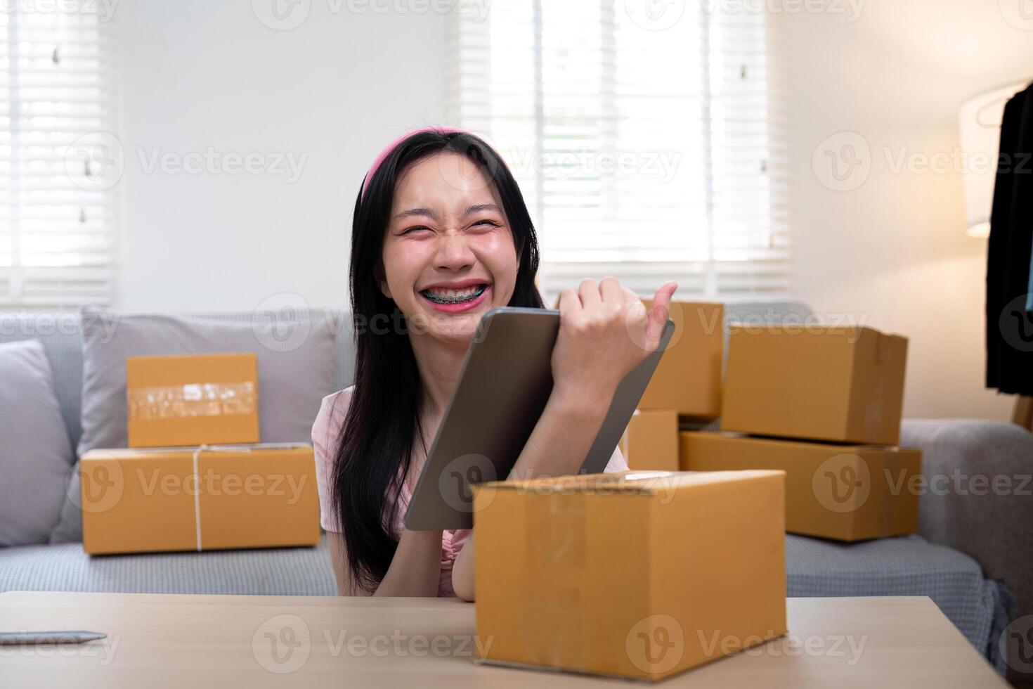 Woman asian in an online store check the customer address and package information on the laptop. Online shopping concept photo