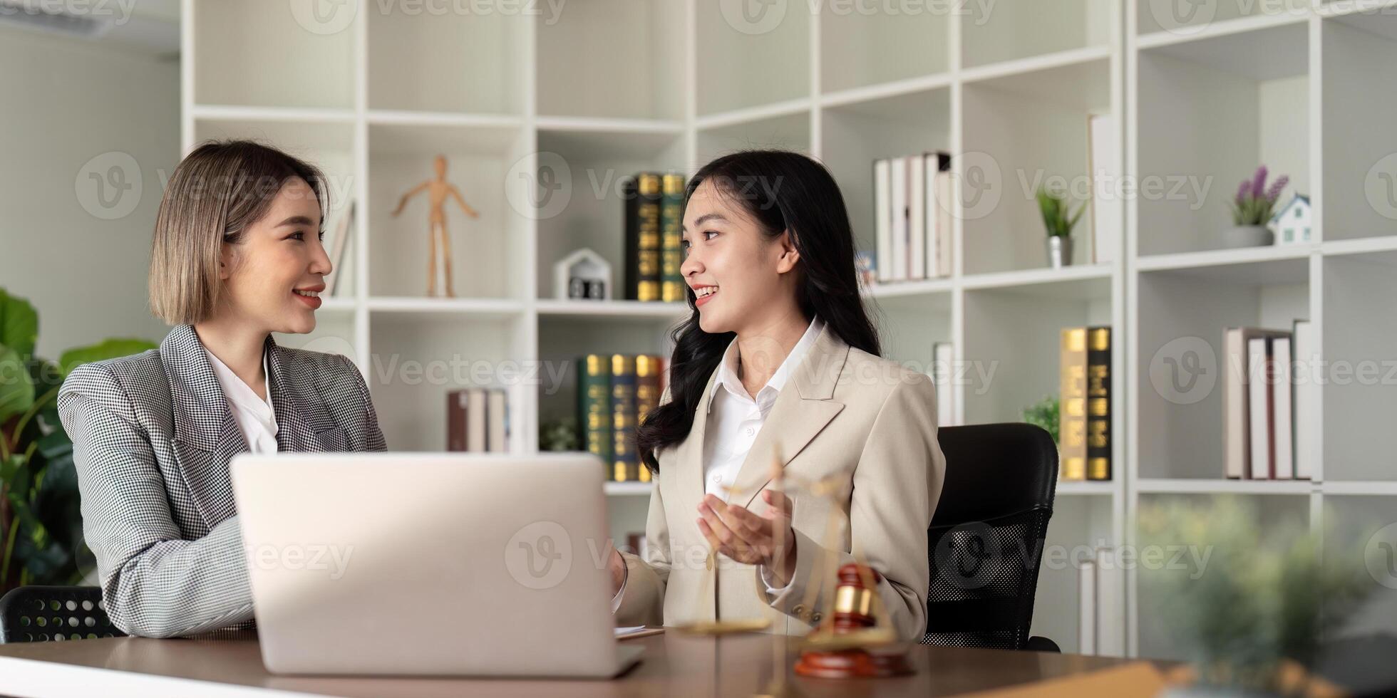 Lawyers woman and businesswoman discussing contract papers sitting at the table. Concepts of law, advice, legal service photo