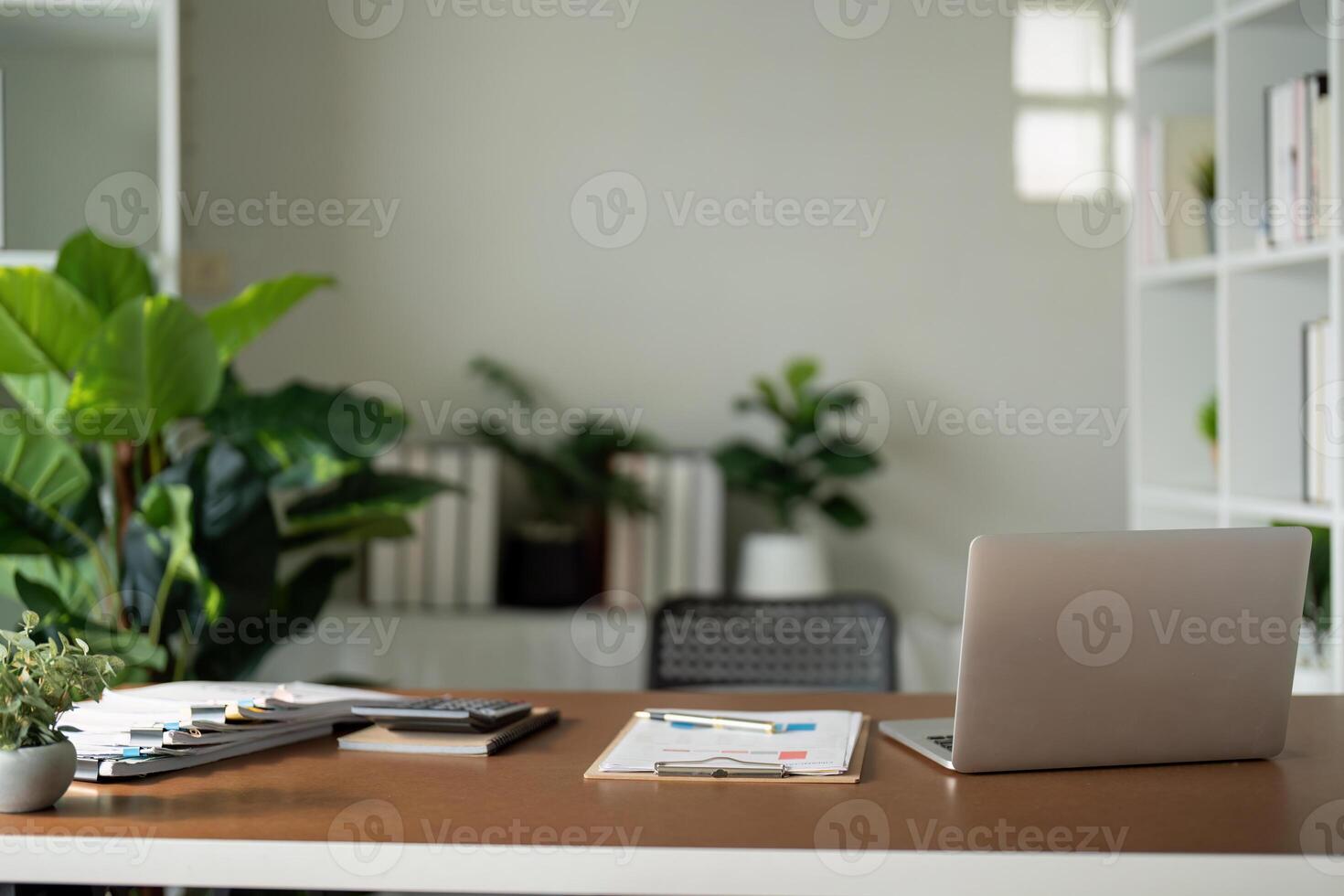 Empty workplace with desk and plant in office room, copy space. work from an atmospheric home office full of green plant photo