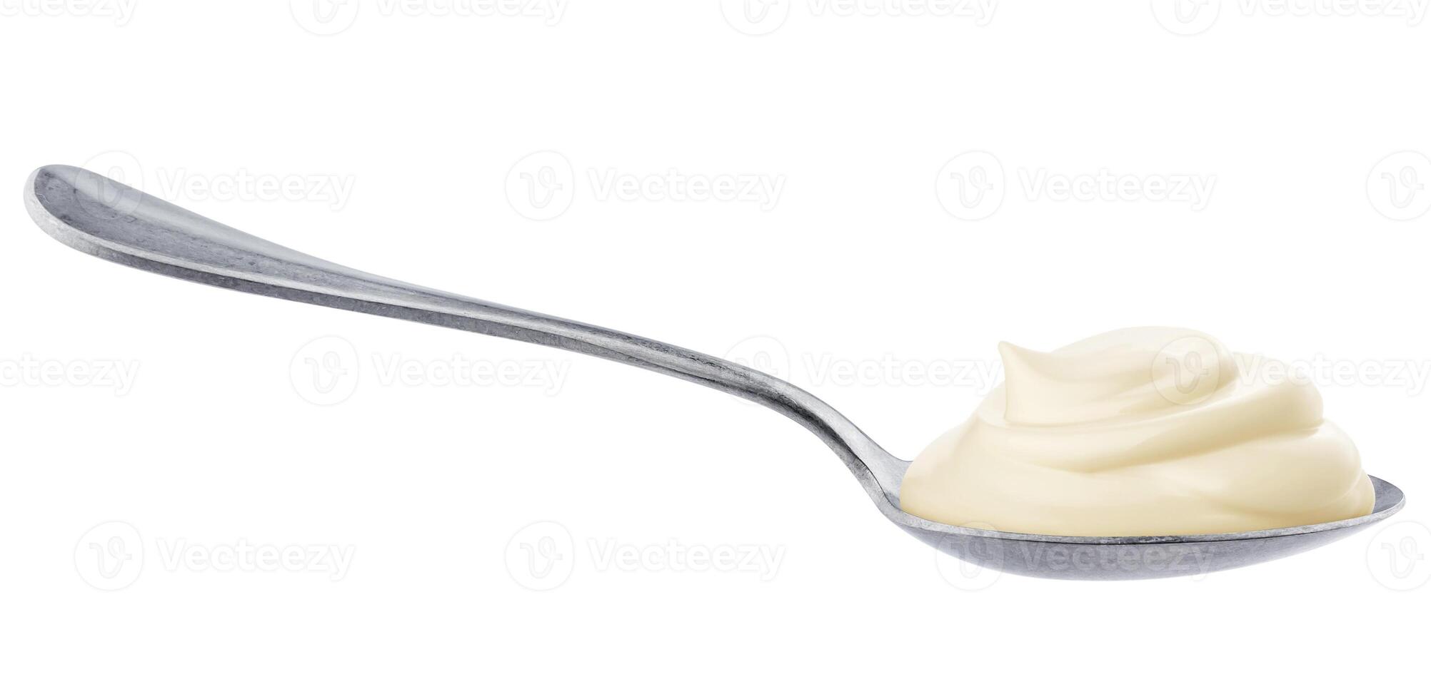 Sour cream in spoon isolated on white background photo