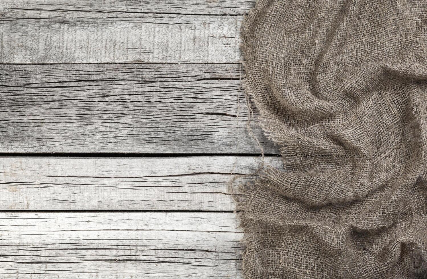 Burlap on old gray wooden background photo