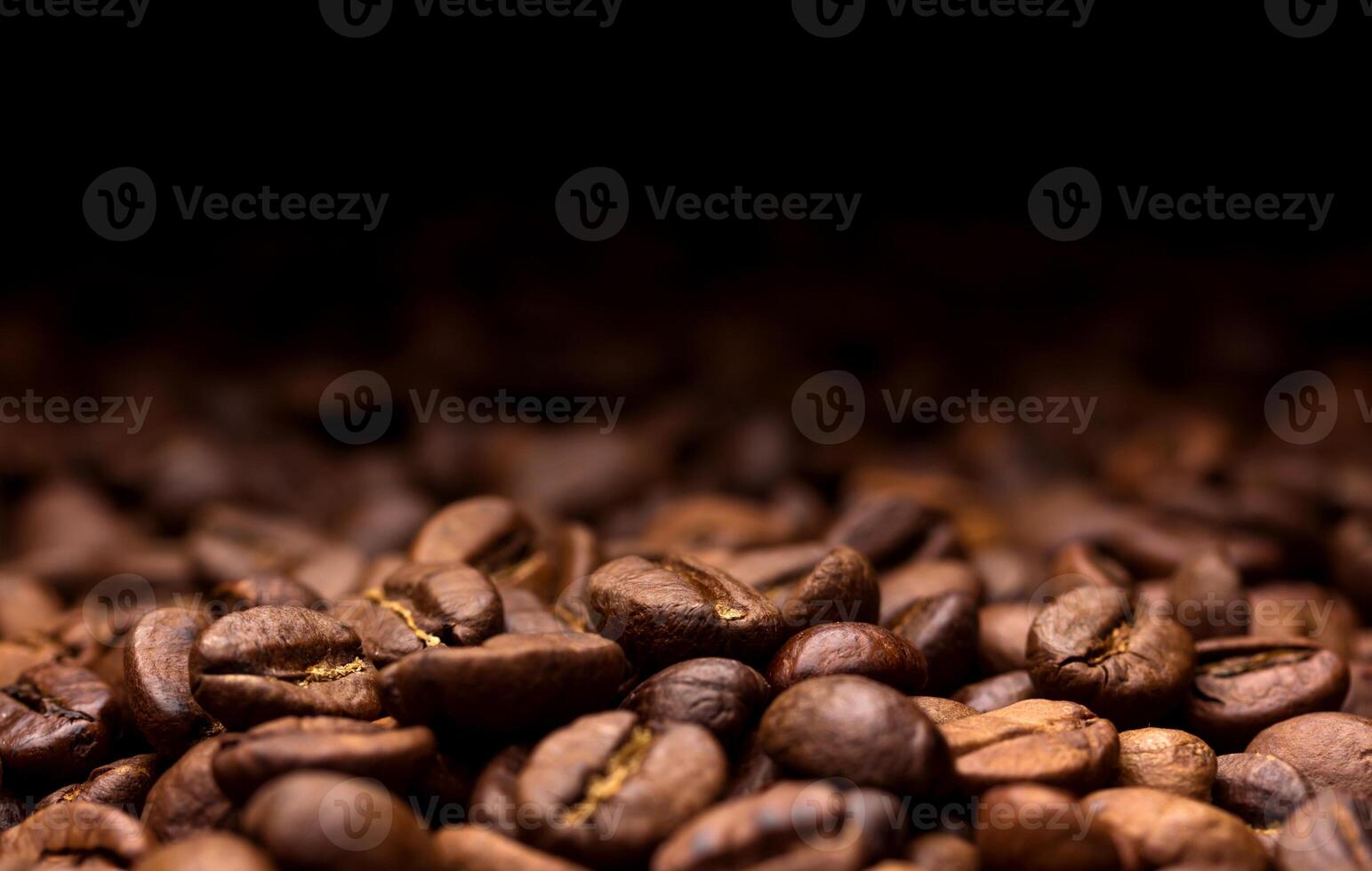 Coffee beans. Dark background with copy space, close-up photo