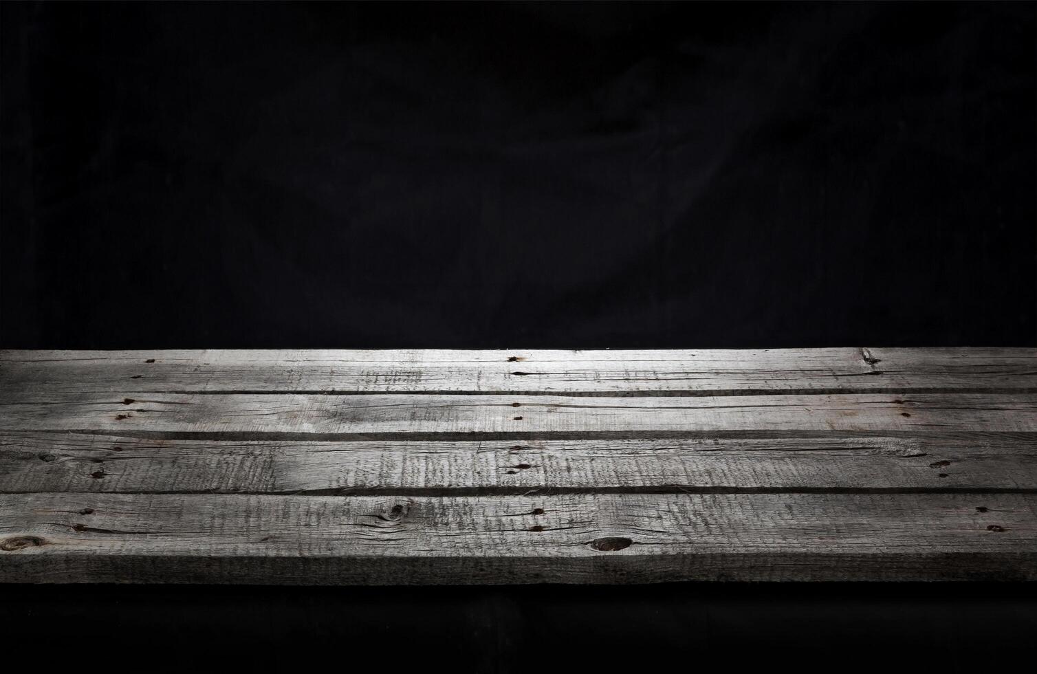 Black wooden table for product presentation, dark background photo