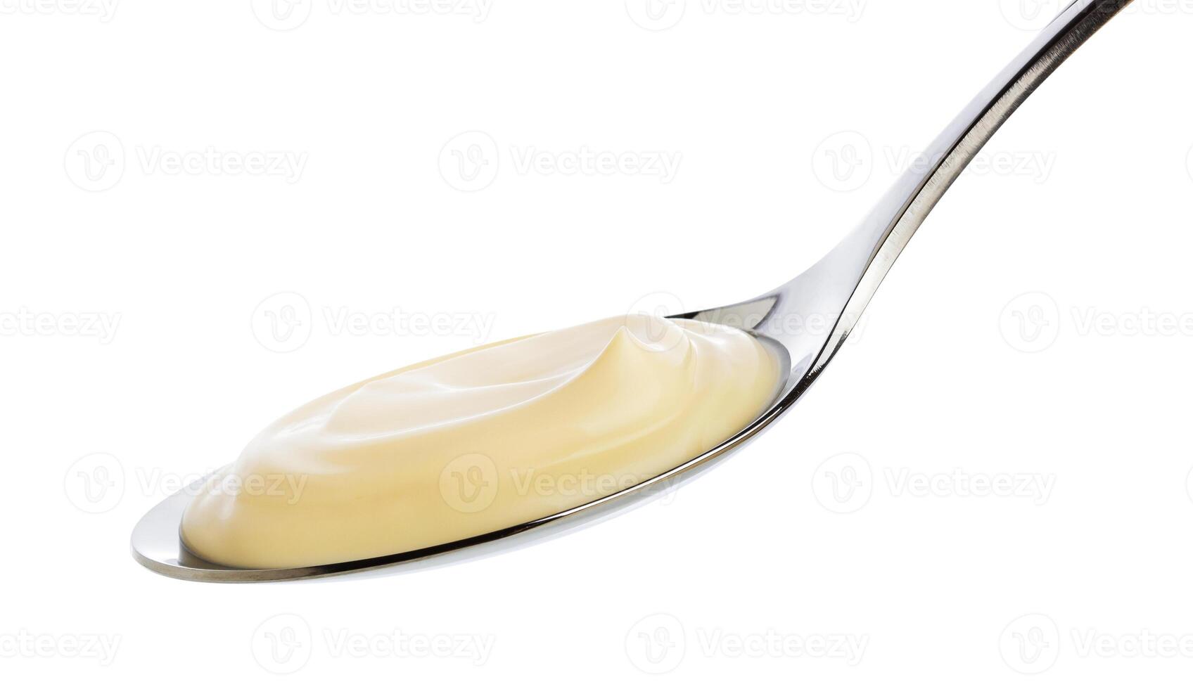 Sour cream in spoon isolated on white background with clipping path photo