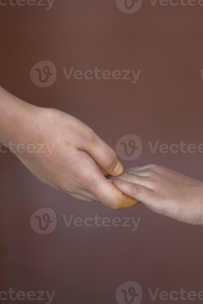 mother holding her child's hand photo