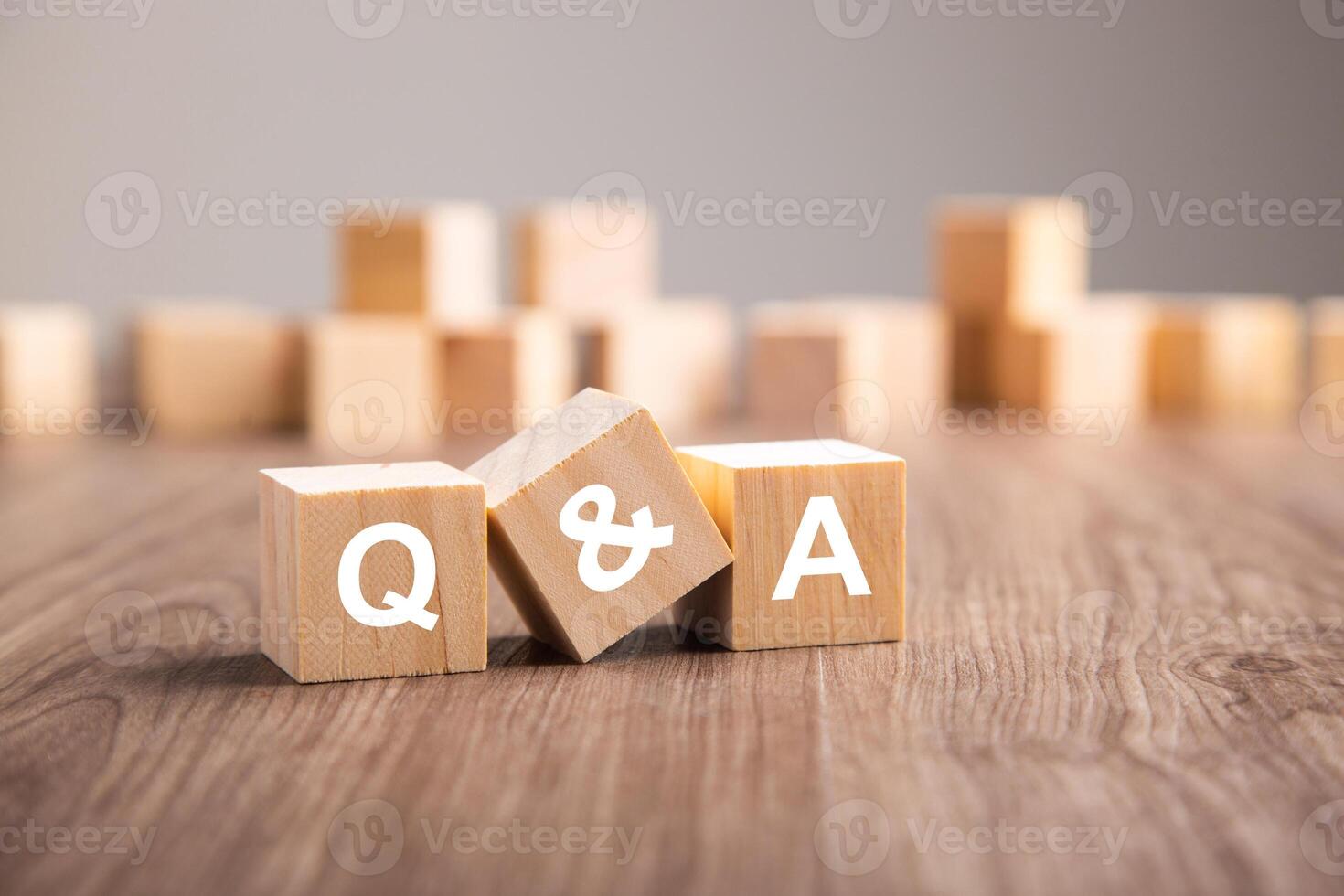 Three wooden cubes with the letters Q and A. photo