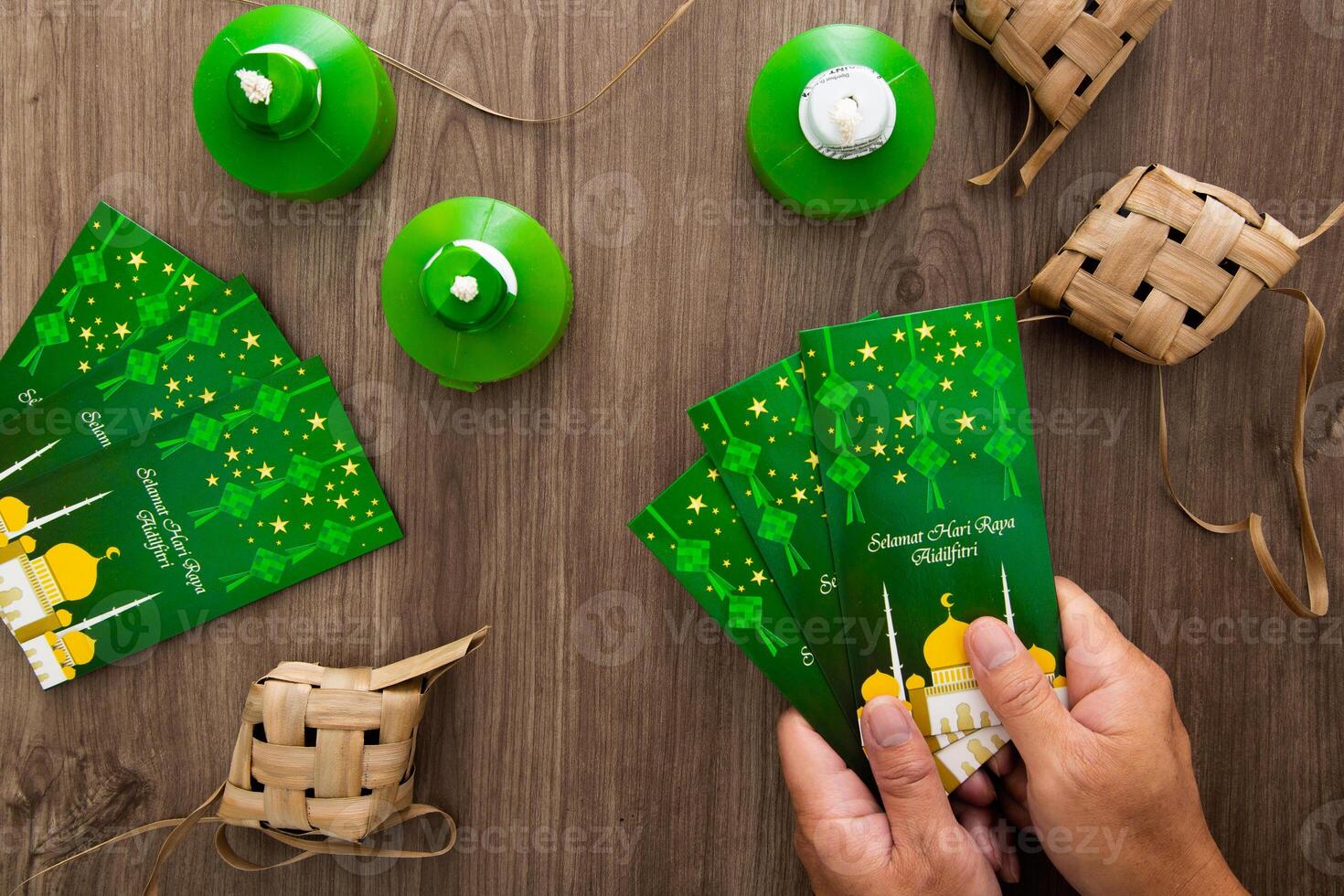 Hand holding Money envelop for muslim Eid celebration photo