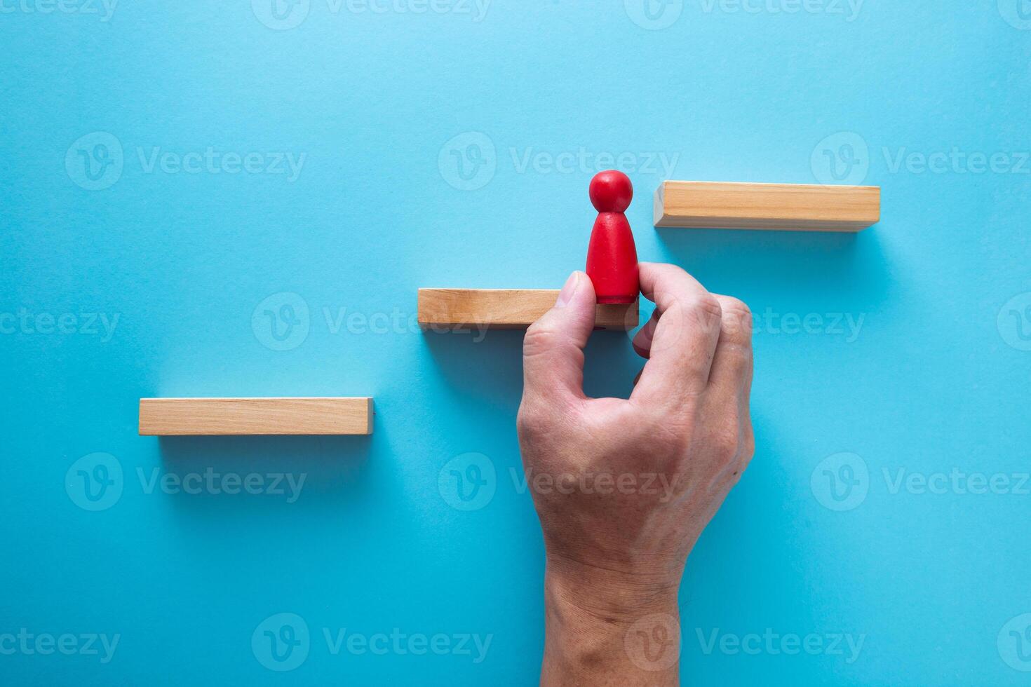 wooden figures standing on wooden block, business team competition concept. photo