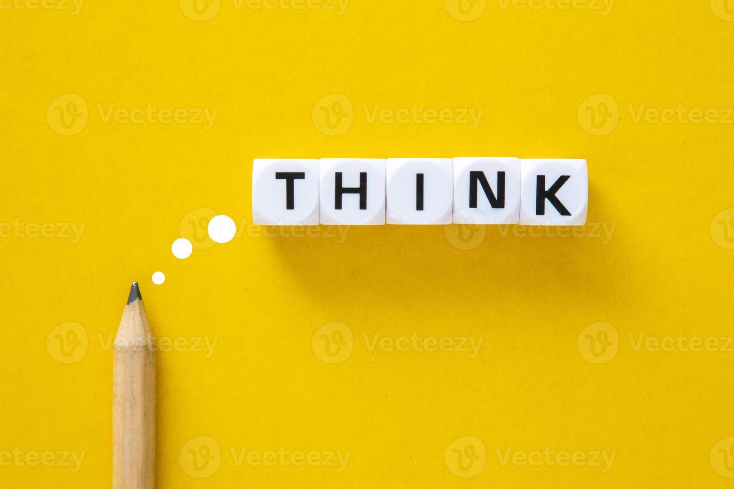 Thinking for creative ideas concept. Pencil with the word think on yellow background. photo