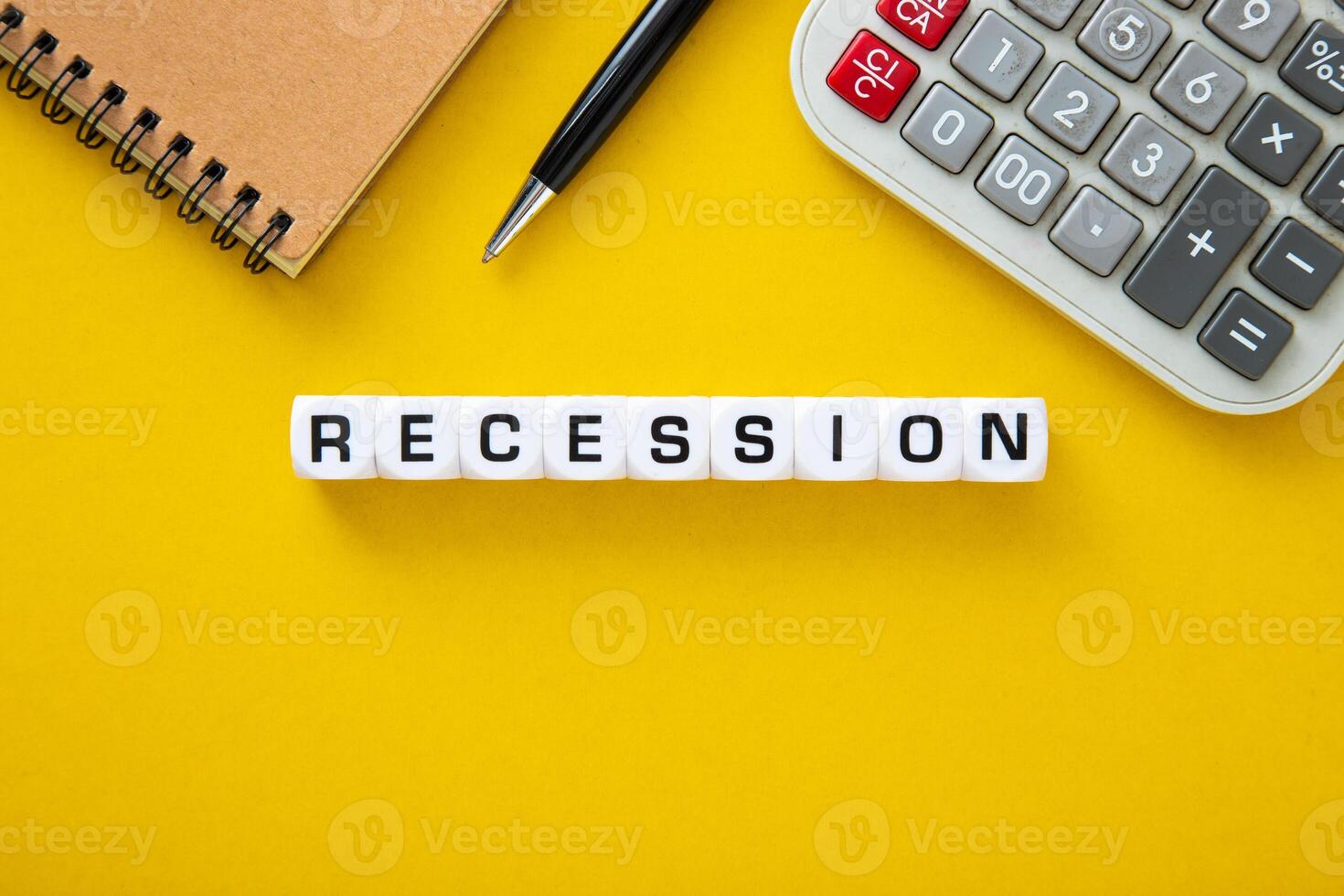 Recessios word on yellow background. Downturn Economy Concept photo
