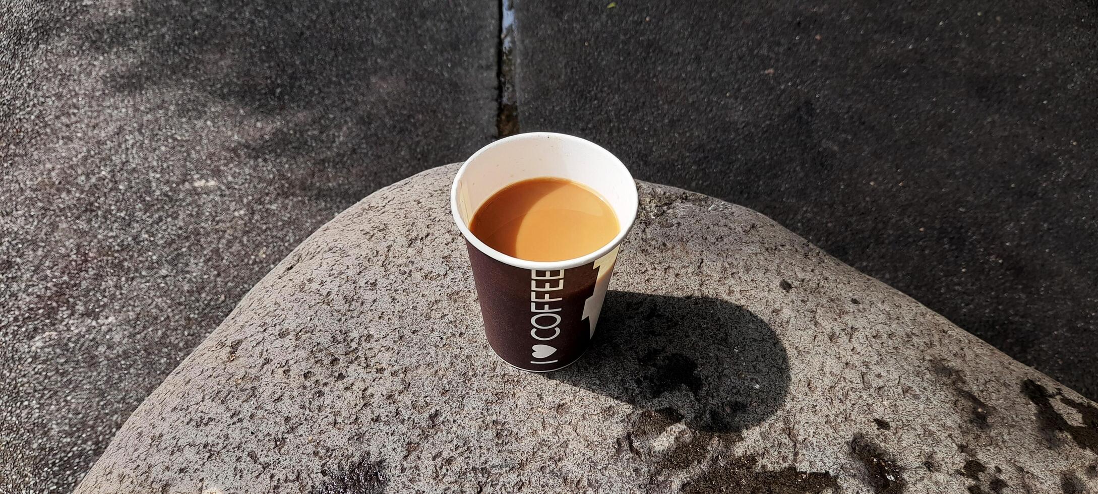 AI generated cup of coffee on a large rock photo