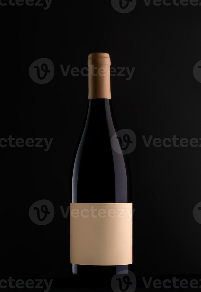 Red wine bottle with blank label on black background. Easily apply your custom design on the label. Mockup photo