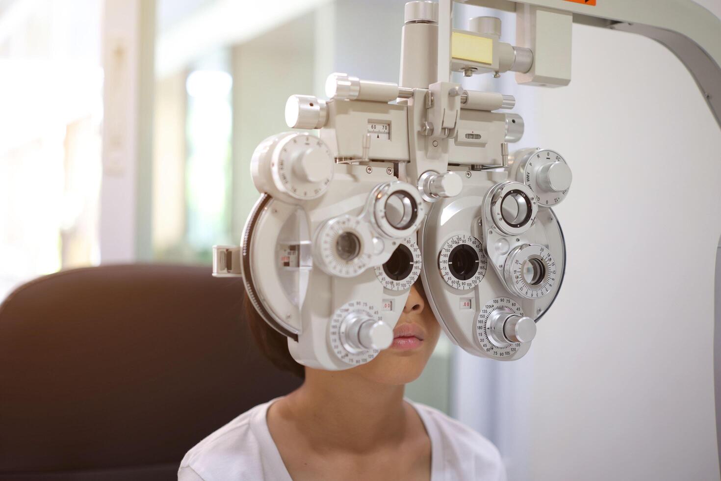 Child eye exam, kid eye test, Phoropter eye test photo