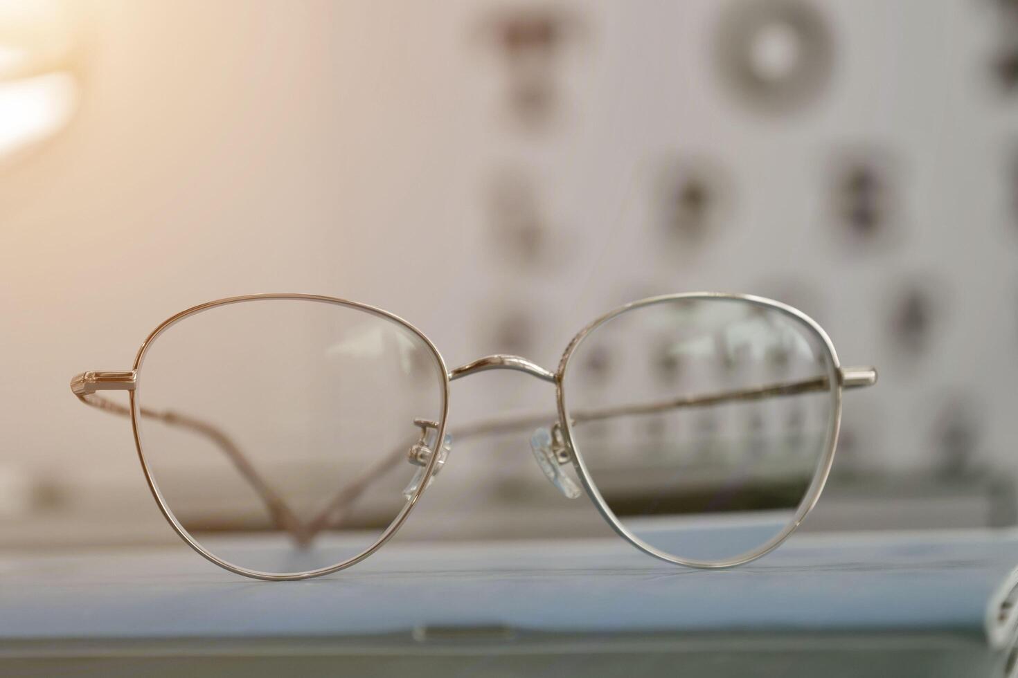 Eyeglasses on table, progressive lenses, eyeglasses for the elderly, glasses progressive lens, eyeglass progressive lens, close-up of glasses on lenses test, looking through glasses photo