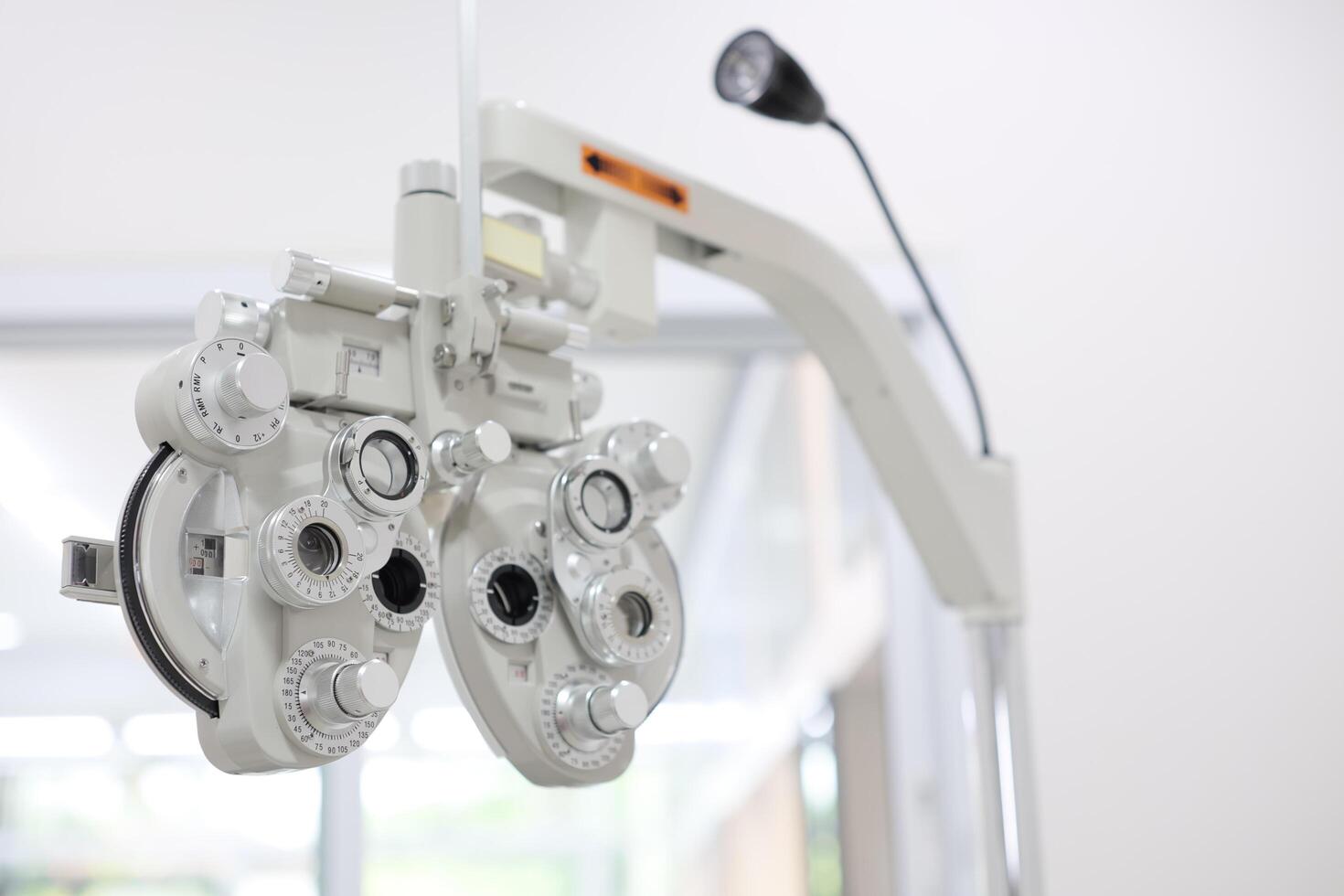 Phoropter for eye test, lenses glasses for eye check in optical store photo