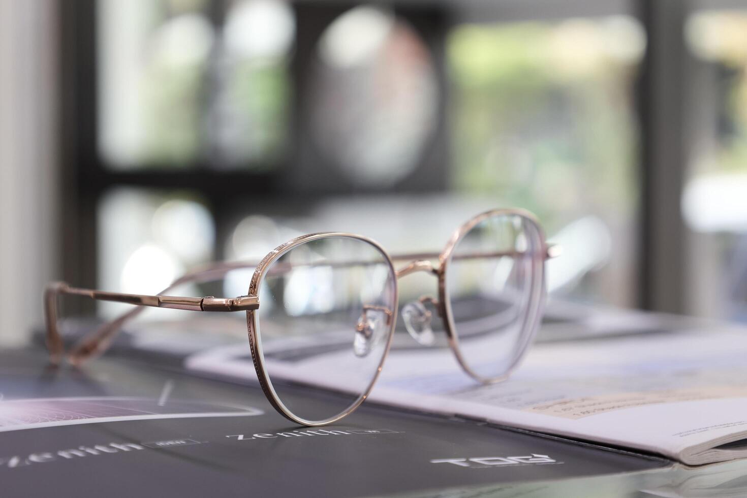 Eyeglasses on table, progressive lenses, eyeglasses for the elderly, glasses progressive lens, eyeglass progressive lens, close-up of glasses on lenses test, looking through glasses photo