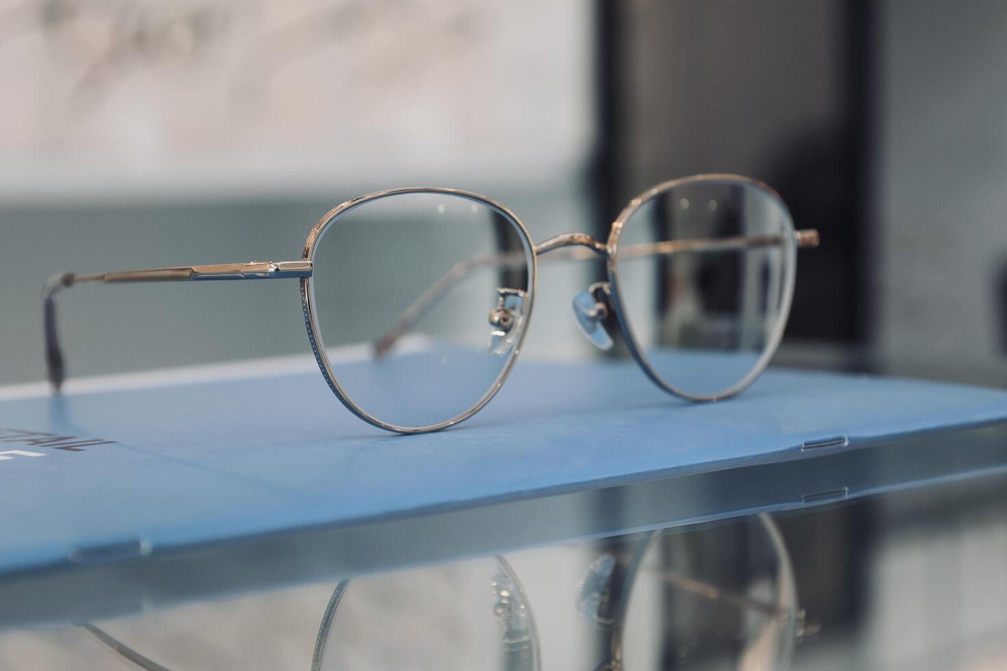 Eyeglasses on table, progressive lenses, eyeglasses for the elderly, glasses progressive lens, eyeglass progressive lens, close-up of glasses on lenses test, looking through glasses photo