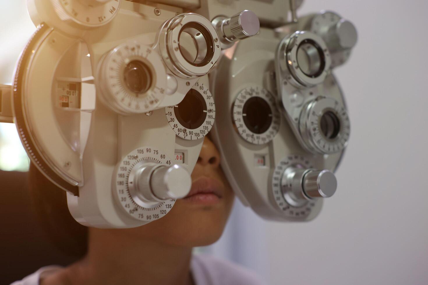 Child eye exam, kid eye test, Phoropter eye test photo