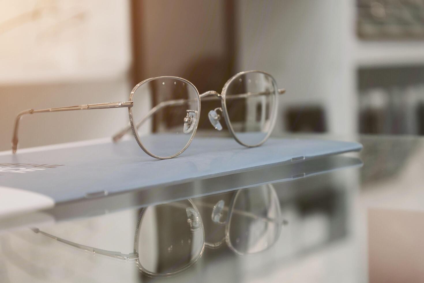 Eyeglasses on table, progressive lenses, eyeglasses for the elderly, glasses progressive lens, eyeglass progressive lens, close-up of glasses on lenses test, looking through glasses photo