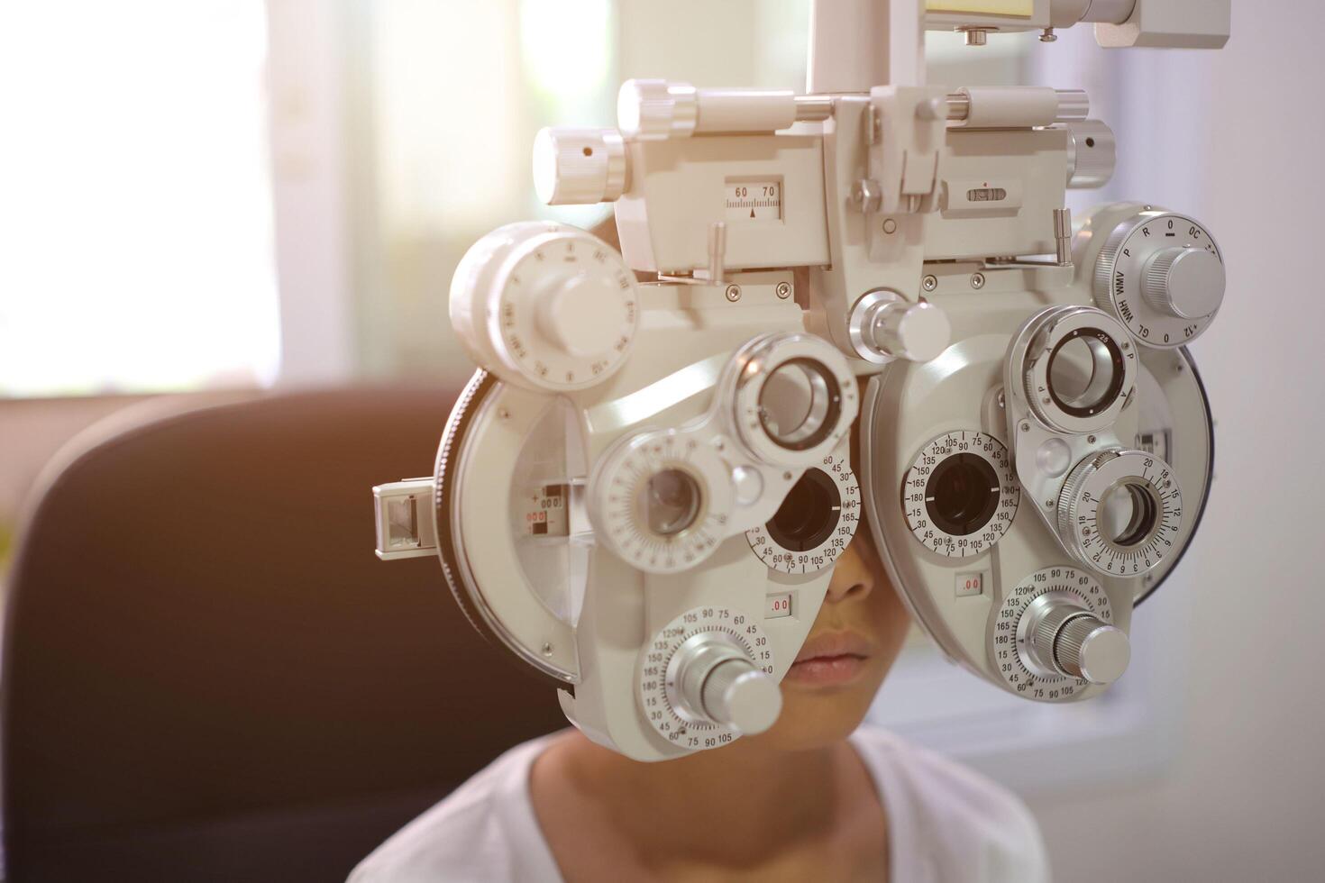 Child eye exam, kid eye test, Phoropter eye test photo