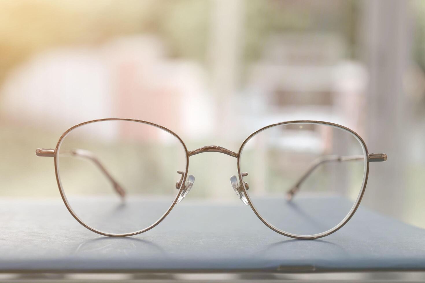 Eyeglasses on table, progressive lenses, eyeglasses for the elderly, glasses progressive lens, eyeglass progressive lens, close-up of glasses on lenses test, looking through glasses photo