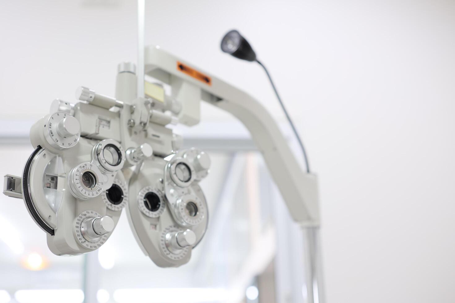 Phoropter for eye test, lenses glasses for eye check in optical store photo