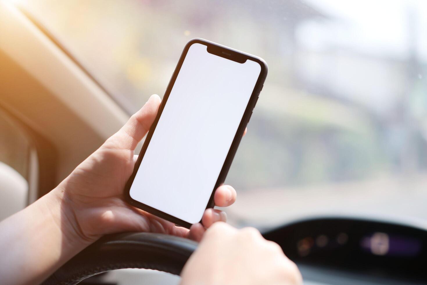 Person using phone on car photo