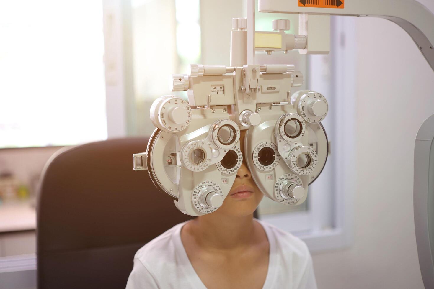 Child eye exam, kid eye test, Phoropter eye test photo