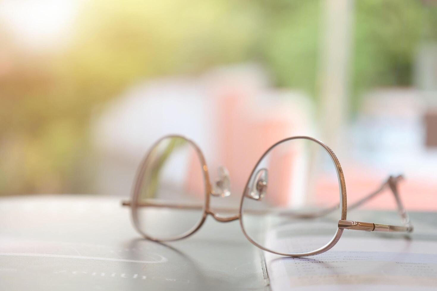 Eyeglasses on table, progressive lenses, eyeglasses for the elderly, glasses progressive lens, eyeglass progressive lens, close-up of glasses on lenses test, looking through glasses photo