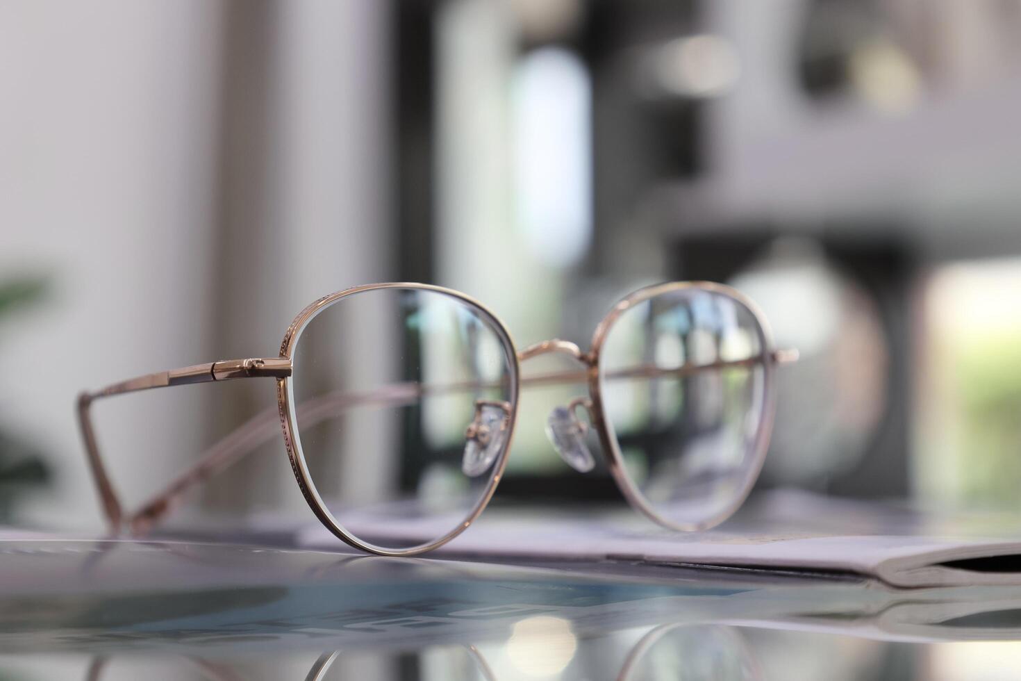 Eyeglasses on table, progressive lenses, eyeglasses for the elderly, glasses progressive lens, eyeglass progressive lens, close-up of glasses on lenses test, looking through glasses photo