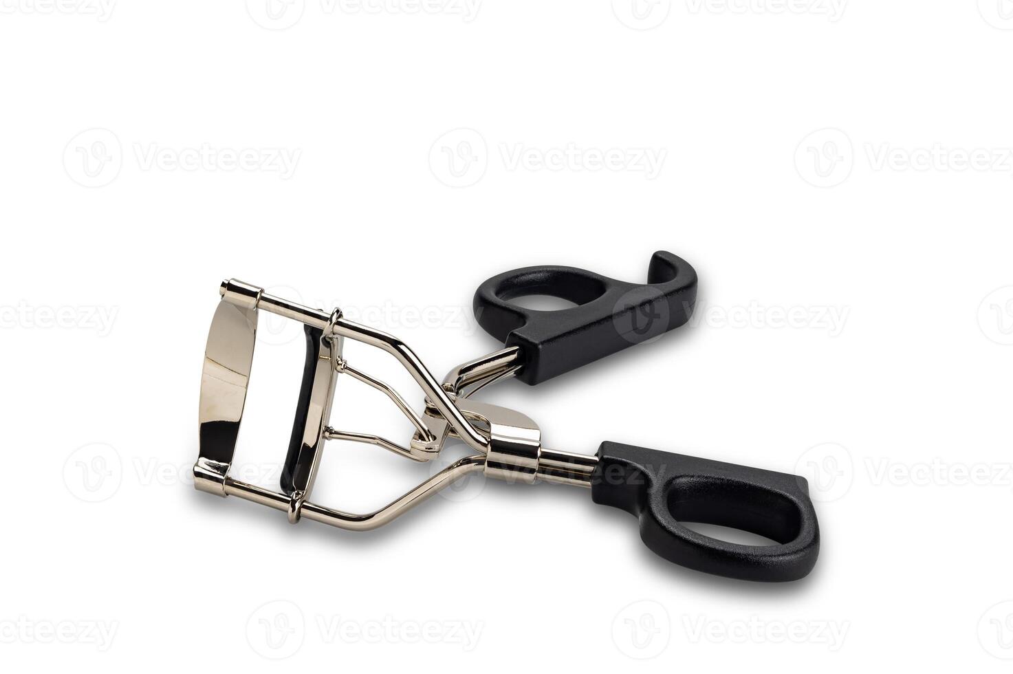 High angle view of metal eyelash curler with black plastic handles isolated on white background with clipping path. photo